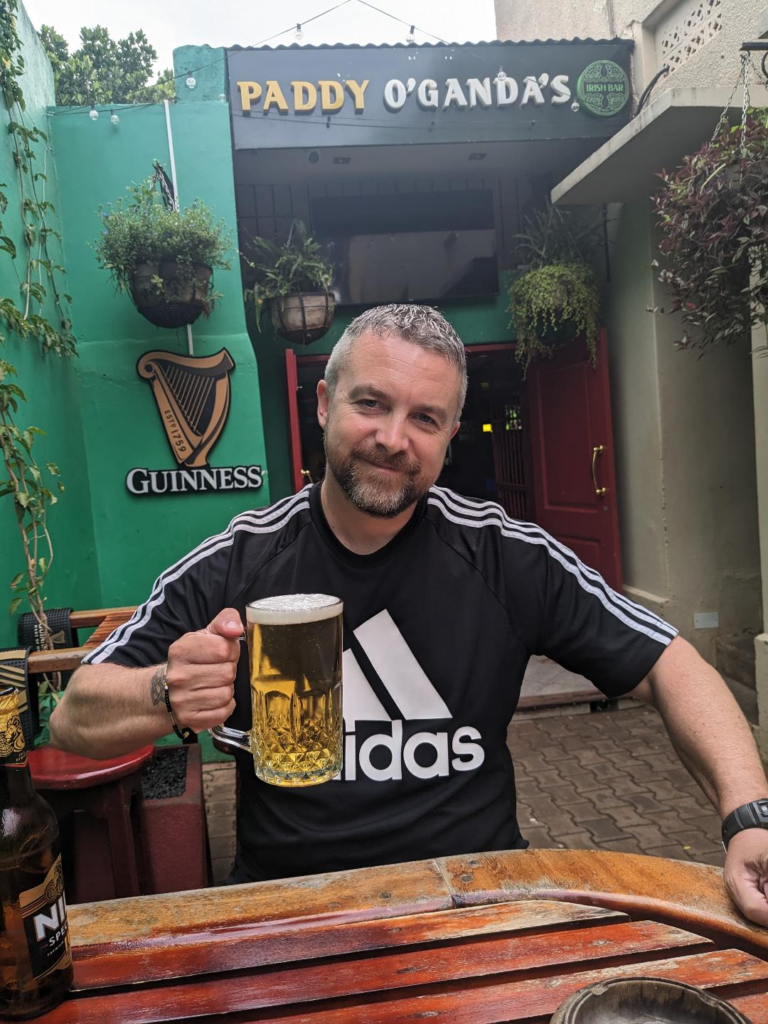 Paddy O'Ganda Irish Bar, Entebbe Uganda - Kevin from happy Irish Wanderers having a pint