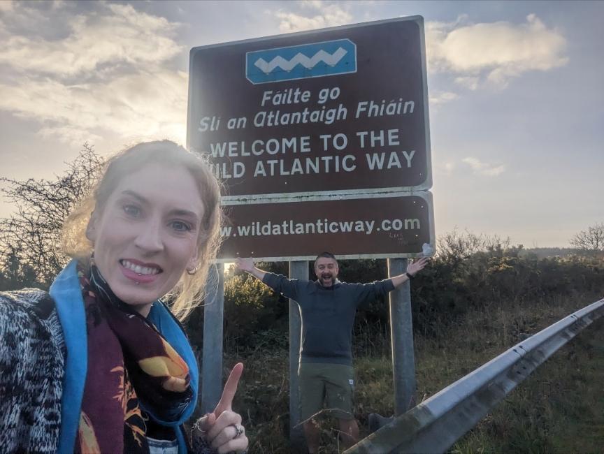 posing with the wild atlantic way sign. Famous Ireland Landmarks: 101 of The Greatest Attractions - 41-60 Happy Irish Wanderers