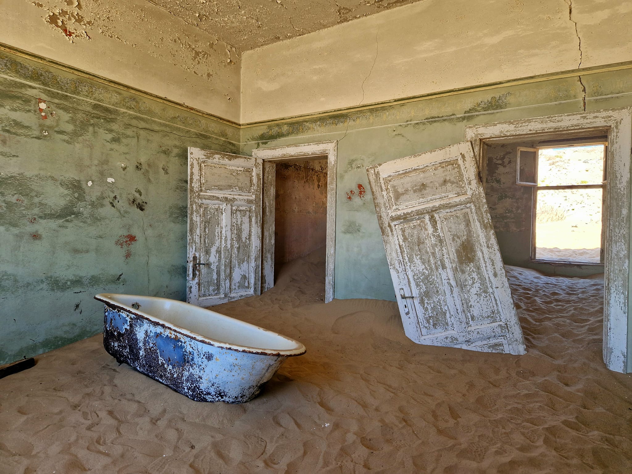 A bathroom covered in sand in Kolmanskop. Best things to do in Namibia: Kolmanskop