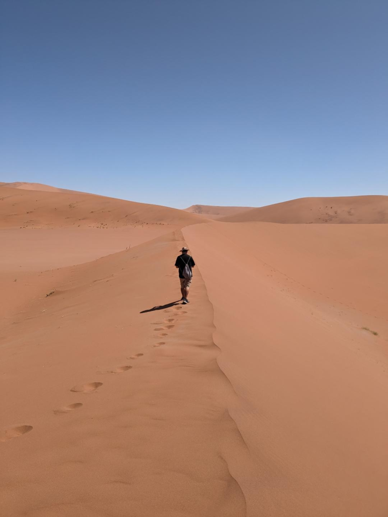 Kevin walking the sand dunes of Deadvlei/Sossusvlei in Namibia Ultimate Guide to Visit Sossusvlei - All Your Questions Answered Right Here Happy Irish Wanderers