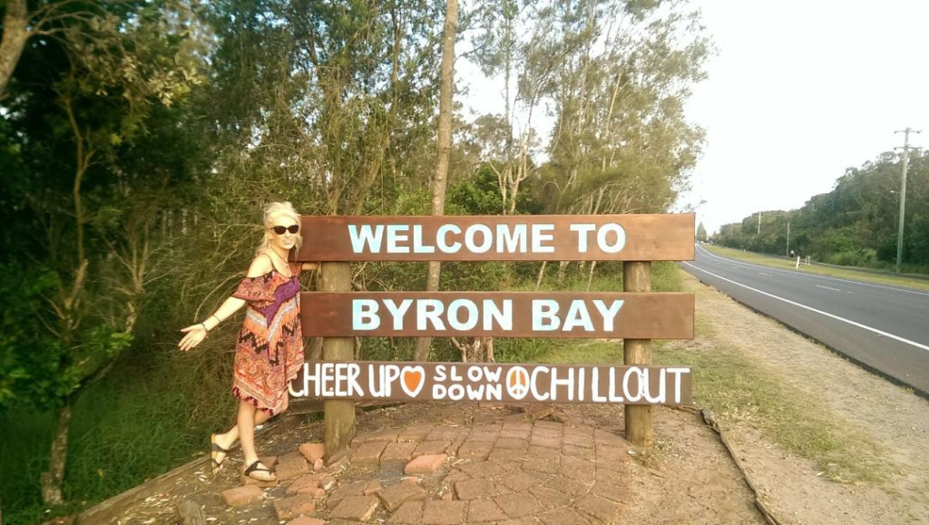 Kate at the welcome to Byron Bay sign post. Things To Do in Byron Bay- The Best Activities Now Happy Irish Wanderers