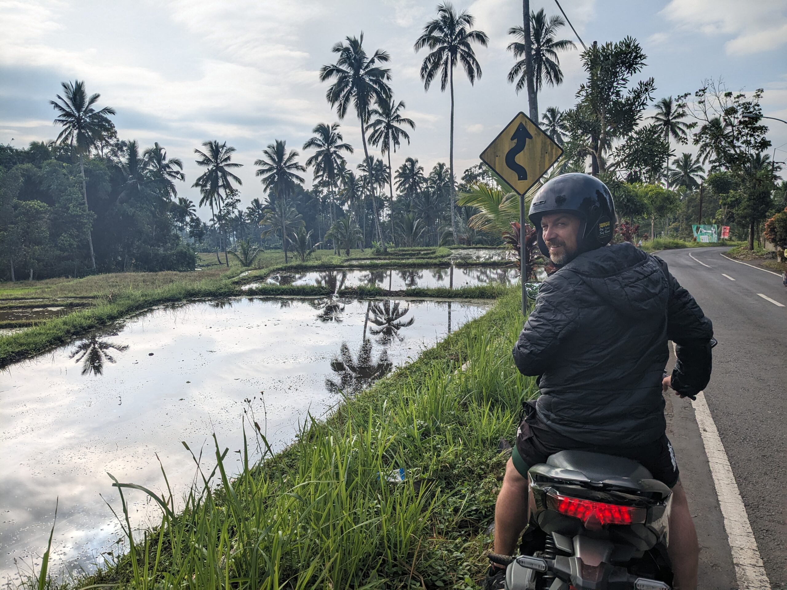 Kevin wearing a helmet on a scooter t in Indonesia Holiday - The Best Advice to Know Before you go Happy Irish Wanderers