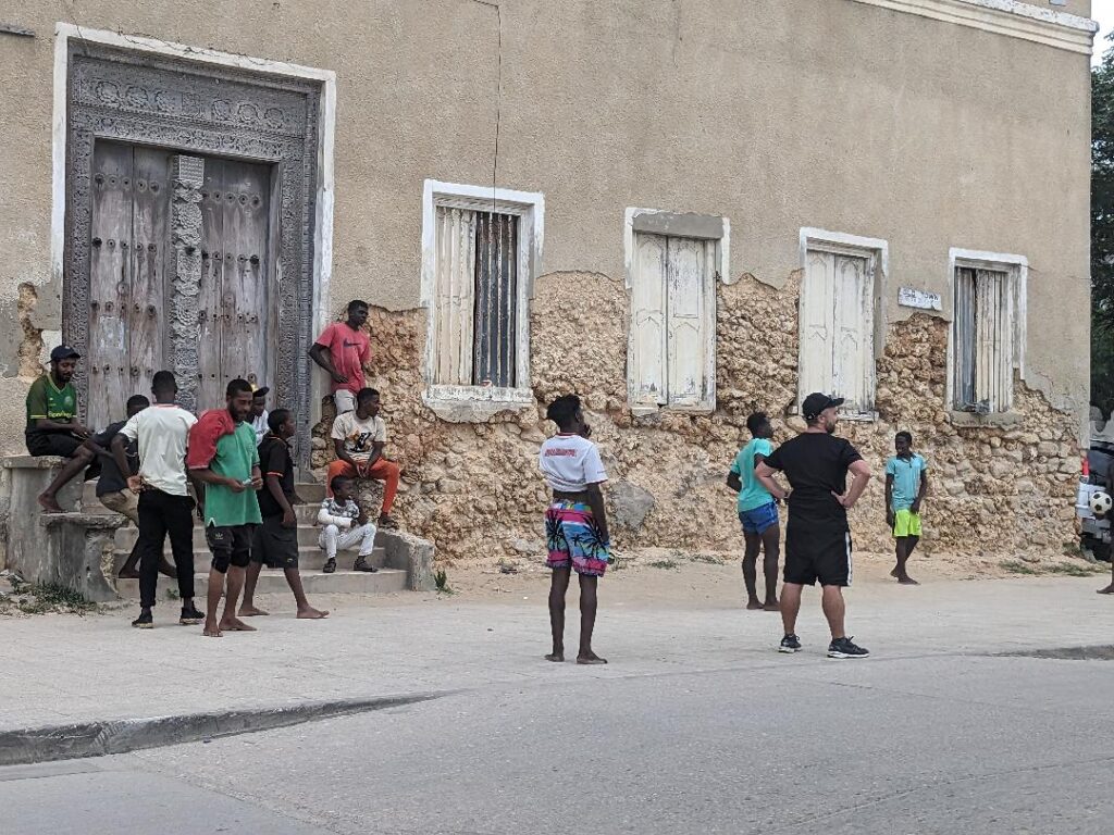 Kevin playing football with locals in Stone Town Happy Irish Wanderers