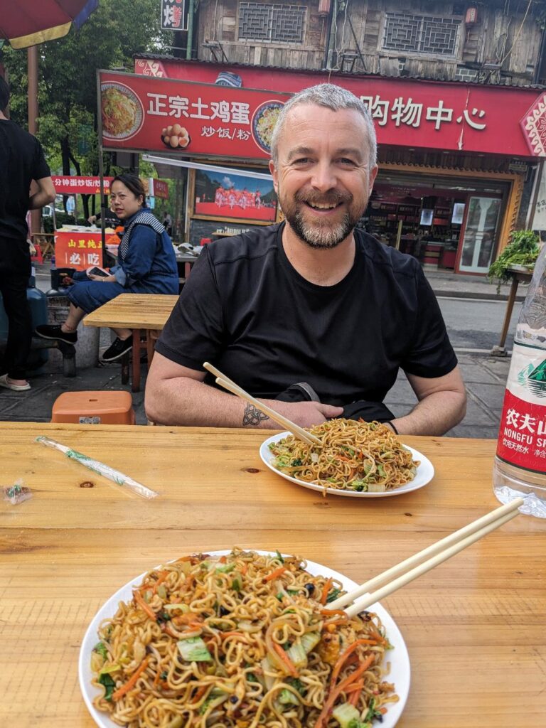 Kevin-eating-street-food-on-our-China-trip-Happy-Irish-Wanderers