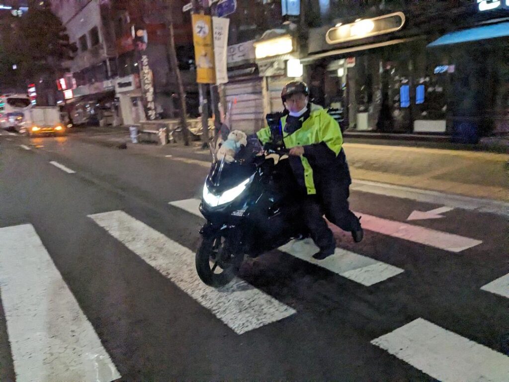 Motorcyclists walking his bike across the street in Seoul in South Korea Travel Happy Irish Wanderers