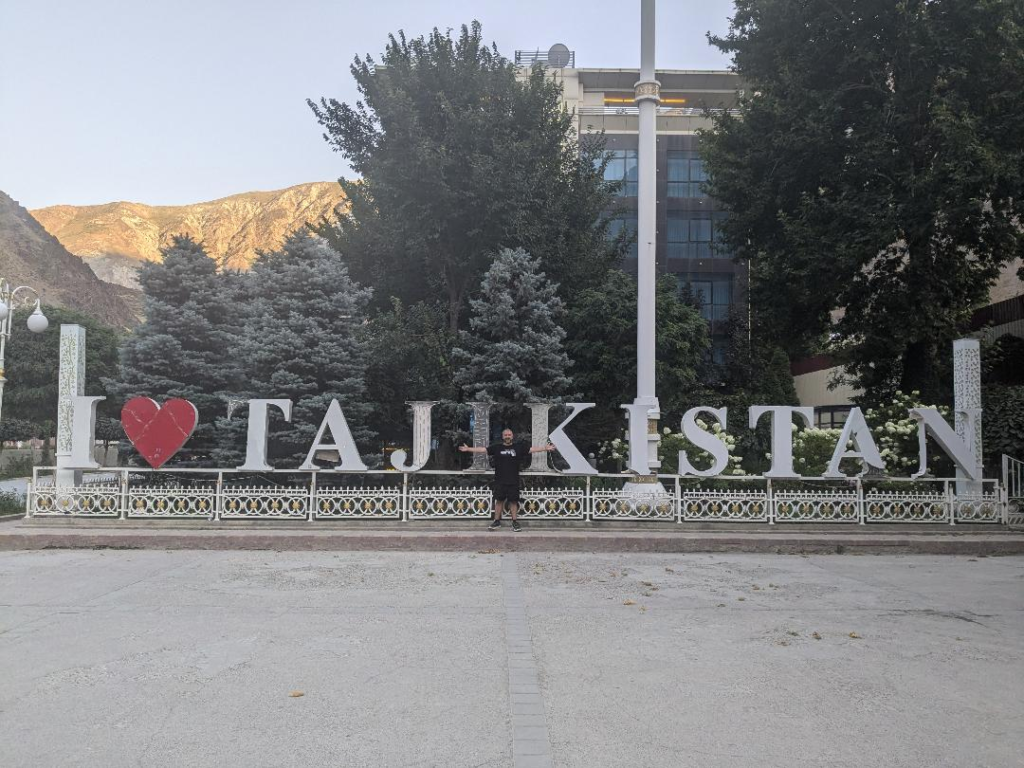 Tajikistan holiday Kevin with the I love Tajikistan sign Happy Irish Wanderers