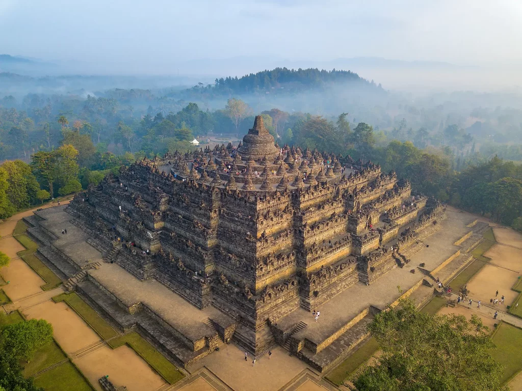 Borobudur Temple surrounded by misty landscape