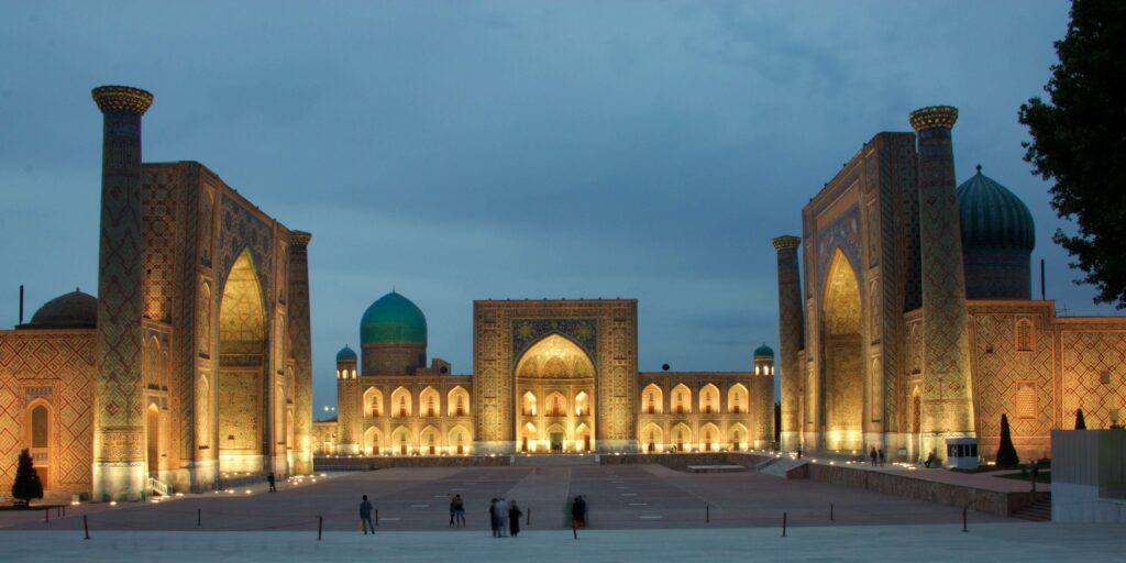 Registan Square lit up at night in Samarkand, Uzbekistan