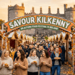 Savour Kilkenny autumn food festival in Ireland with stalls, crowds, and Kilkenny Castle in the background.