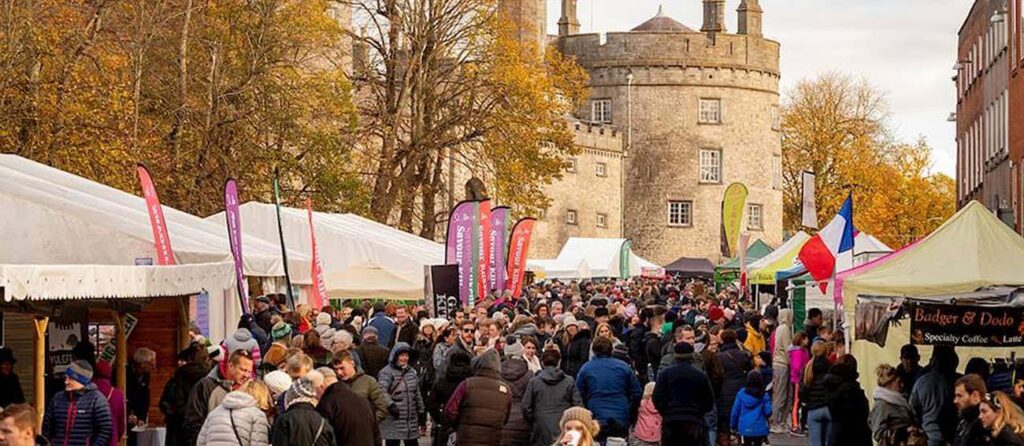 Savour Kilkenny food stalls with Kilkenny Castle background