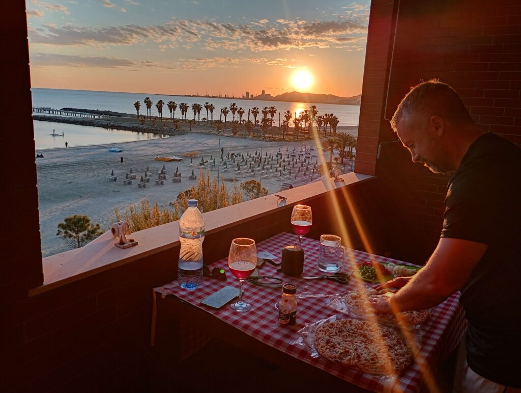 Living in Albania: sunset views whilie preparing food on beachfront apartment in Durres